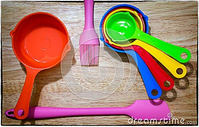 Set of Colorful Measuring Spoon, pink Spatula and Brush on a Woo Stock Photo