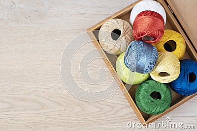 Set of colorful threads for knitting, crocheting in wooden box on the table Stock Photo