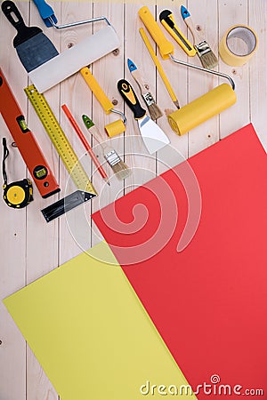 Set of construction tools and colored paper on wooden table Stock Photo