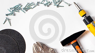 A set of construction tools and fittings for repair - hammer, screwdriver, self-cutters, cut circle. With a place for text in the Stock Photo