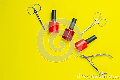 A set of cosmetic tools for manicure and pedicure. Manicure scissors, cuticles, saws, miller stand on a yallow background. Top Stock Photo