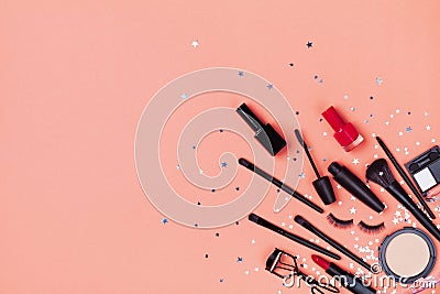 Set of decorative cosmetic and beauty products for makeup on star confetti background top view. Flat lay style Stock Photo