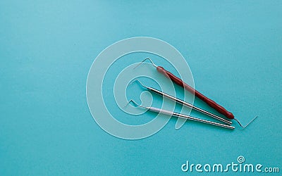 Set of dental probe for periodontal inspection on blue background. Stock Photo