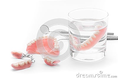 Set of Denture in glass of water and tools on white background Stock Photo