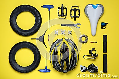 Set of different bicycle tools and parts on yellow background, flat lay Stock Photo
