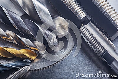 Set of different drill bits,thread tap and mill cutters on steel plate background. Locksmithing deal Stock Photo