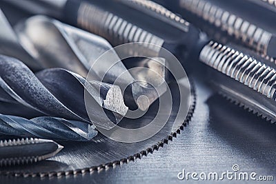 Set of different drill bits,thread tap and mill cutters on steel plate background. Locksmithing deal Stock Photo