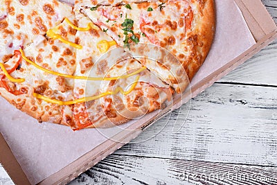 Set of different pieces of pizza in a carton box on white table Stock Photo