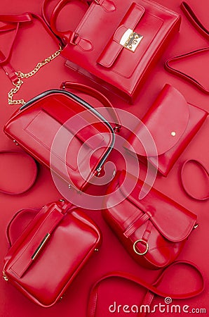 Set of different types of red fashion women handbags on red background. Stock Photo