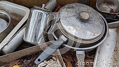 A set of dirty pots teapot and utensils in an outdoor mud kitchen Stock Photo