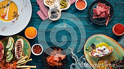 A set of dishes. Pumpkin soup, avocado sandwich, prosciutto, and mushrooms. Top view. Stock Photo