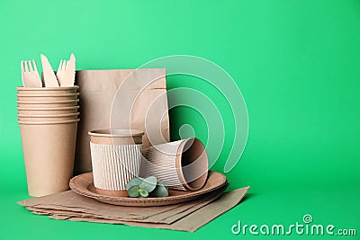 Set of disposable eco friendly dishware on green background Stock Photo