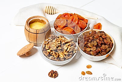 Set of dried berries, fruits and nuts lying in a platewalnuts,pumpkin, cherry, apricot, Apple, dates Stock Photo