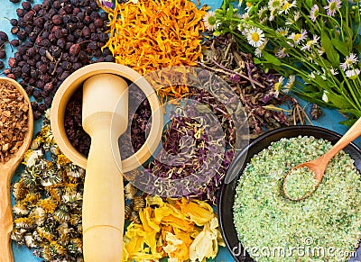 A set of dried flowers and berries, herbs, oak bark, sea salt on old wooden table Stock Photo