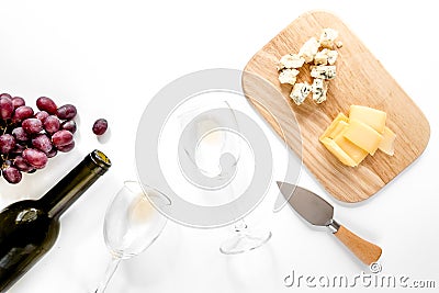 Set for drinking wine with cheese and red grape on white background copyspace top view Stock Photo