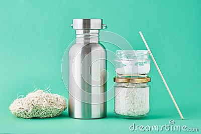 Set of eco friendly items on a green background. Reusable aluminum bottle and glass jar. Zero waste and plastic free concept Stock Photo