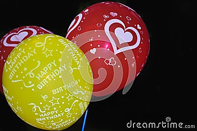 Set of flying balloons of pink green red color. Flying Birthday helium balloon. Isolated on black background. Party celebrations Stock Photo