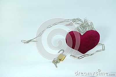 Set free from the shackles. Keys open locked chains of red love heart Stock Photo
