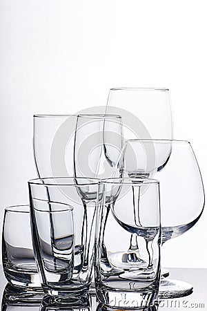 Set of glass empty glasses and goblets on a gray-white background Stock Photo