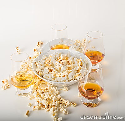 Set of glasses of single malt whisky, salty popcorn in a bowl an Stock Photo
