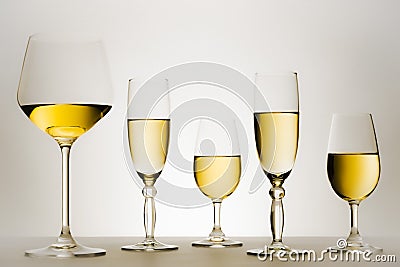 Set of glasses with white wine in series or row. Stock Photo