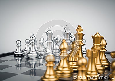 Set of gold and the silver chess pieces, king, rook, bishop, queen, knight, and pawn standing together on the chessboard. Stock Photo
