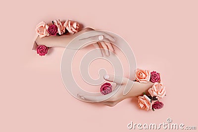 Set hands with artificial flowers sticking out of hole pink paper background. Hand in various poses, the pattern layout for your Stock Photo