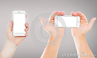 Set hands holding empty blank screen mobile phones on gray background, vertical and horizontal empty display Stock Photo