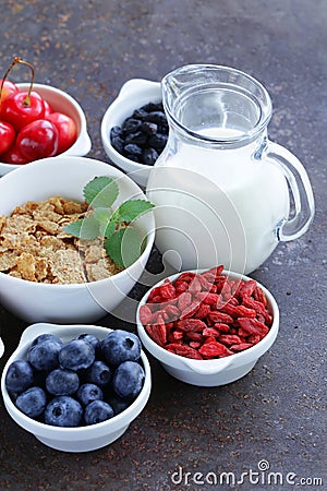 Set of ingredients for a healthy food breakfast - muesli, fresh and dried fruit, nuts, goji Stock Photo