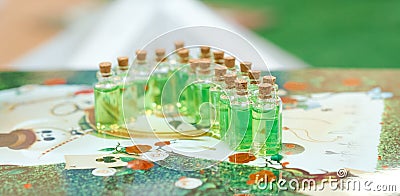 Set of jars with magic green potion on the table Stock Photo