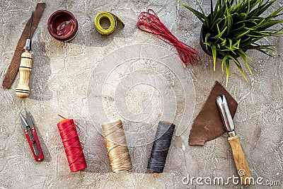 Set of leather craft tools on grey stone background top view copyspace Stock Photo