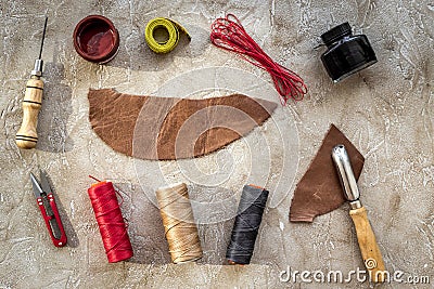 Set of leather craft tools on grey stone background top view mockup Stock Photo