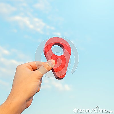 Set location. Red geolocation pin icon in hand. Land market. Tourism and travel. Navigate a route. Location announcement. Stock Photo