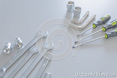 Set of a lot of different tools, such as: combination wrench, socket wrench, arm hexagons keys and three screwdriver in light Stock Photo