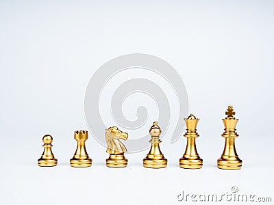 Set of luxury golden chess pieces isolated on white background. Stock Photo