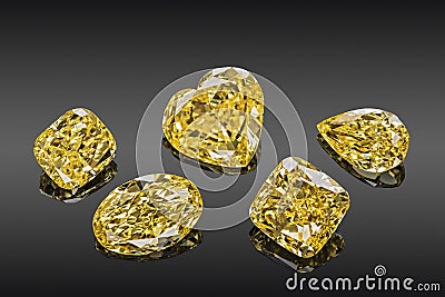 Set of luxury yellow transparent sparkling gemstones of various cut shape diamonds collage isolated on black background Stock Photo