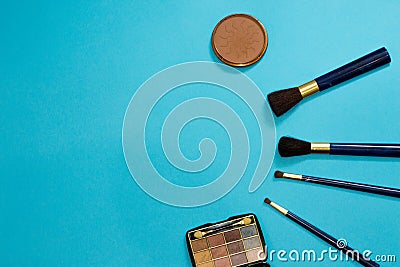 Set of makeup brushes near blusher and brown eye shadows. Woman tools for making evening makeup. Composition with copy space from Stock Photo