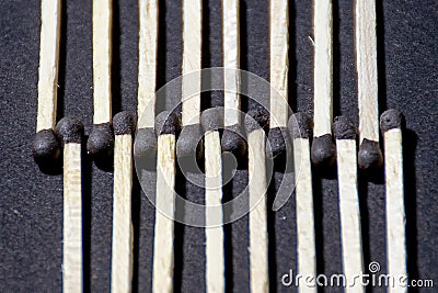 Matchsticks arranged in a wavelike pattern, with match heads aligned in alternating up-and-down positions for a visual effect Stock Photo