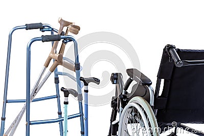 Set of mobility aids including a wheelchair, walker, crutches, quad cane, and crutches. Stock Photo