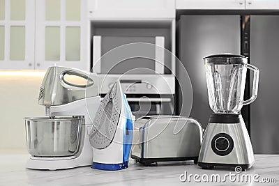 Set of modern home appliances on marble table in kitchen Stock Photo