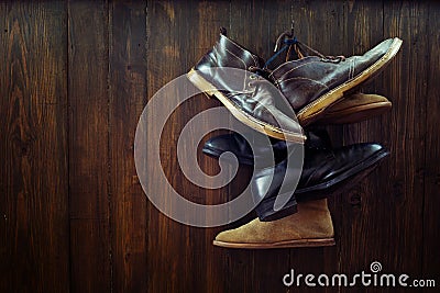 Set of old boots hanging on the nail Stock Photo