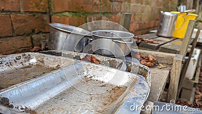 A set of old rusty trays and pots in a childs outdoor mud kitchen Stock Photo