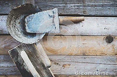 Set of old used masonry tools on a rough wooden surface Stock Photo