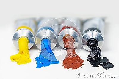 Set of opened color oil paint tubes on a white surface Stock Photo