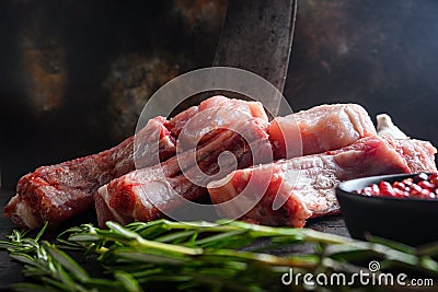 Set organic pork chop steaks over dark background wood and rustic steel, close up selective focus Stock Photo