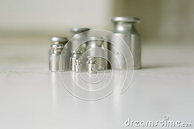 Set of pharmacy laboratory precision weights for a balance scale on an old table. Pharmacy set of small weights Stock Photo