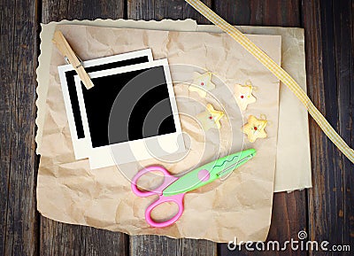 Set of photo frame scissors and crumpled paper on wooden background Stock Photo