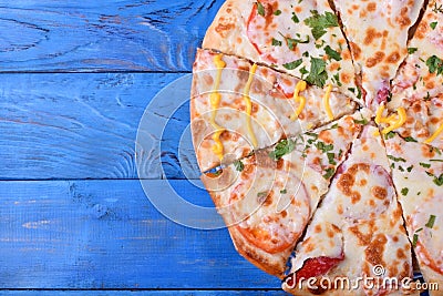 Set of pieces of different kinds of pizza on blue table. Copy space Stock Photo