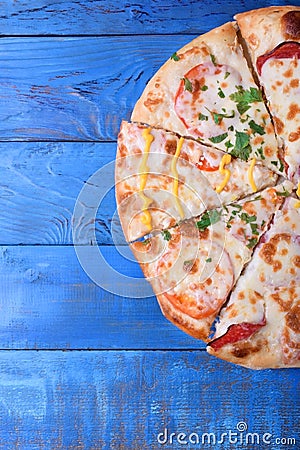Set of pieces of different kinds of pizza on blue table Stock Photo