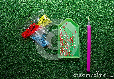 Set - a plastic stylus for a diamond mosaic, glue, rhinestones in bags for DIY Stock Photo